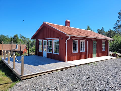 Cheerful cottage with fireplace on archipelago island