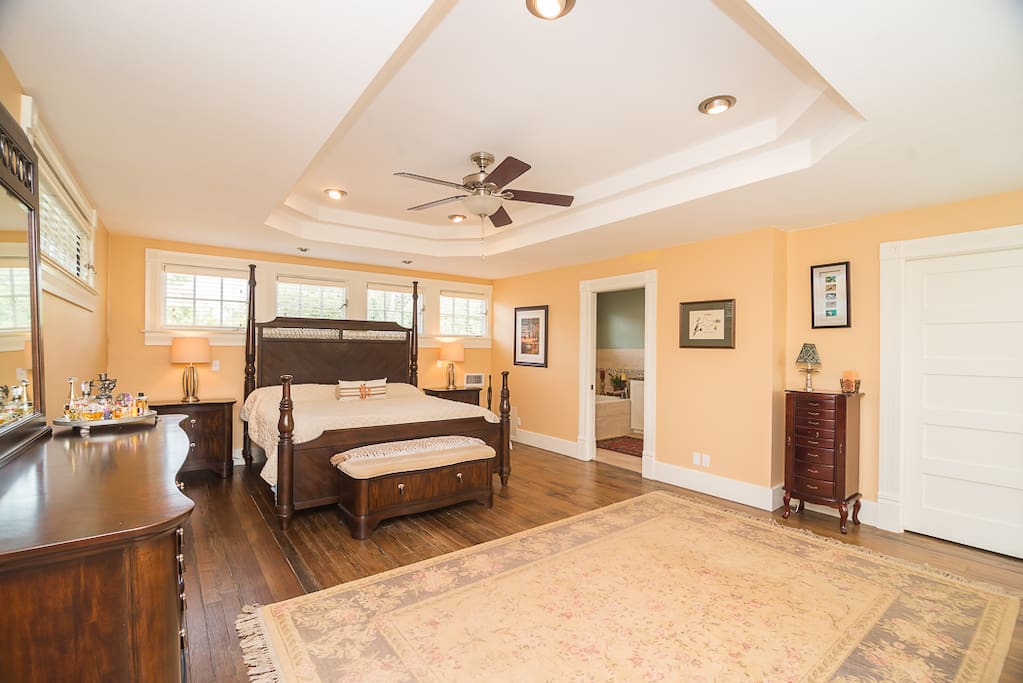 Spacious upstairs master bedroom suite with king bed, Keetsa Pillow Plus mattress, reading nook, and walk-in closet