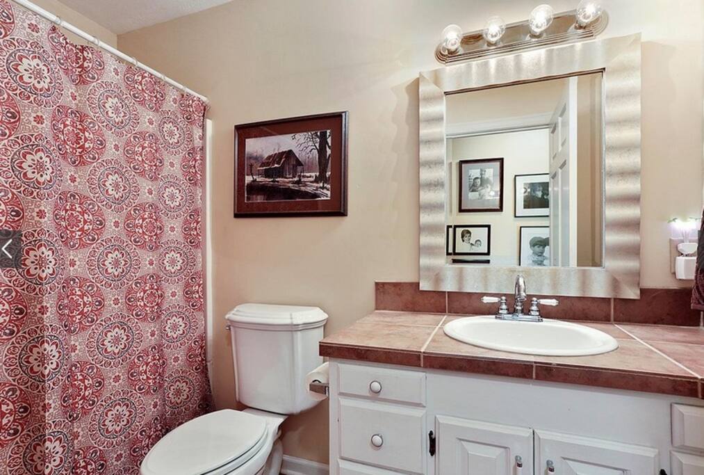 Private bathroom with shower and bathtub.