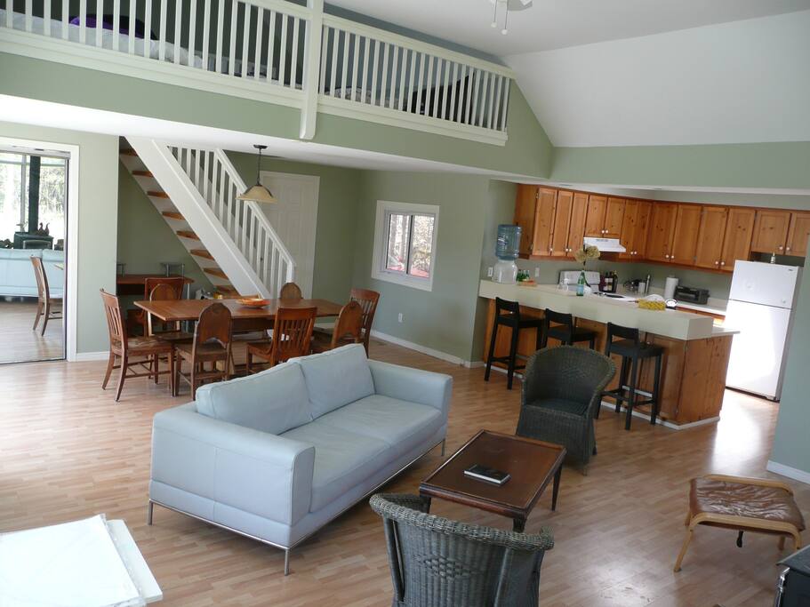 Large dining table and fully stocked kitchen. Open sleeping loft for 3 is up the stairs. Separate bedroom is of to the side.