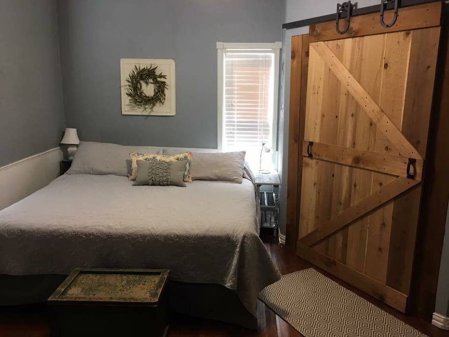 Master bedroom with king size bed. Barn doors complete the cozy country feel!