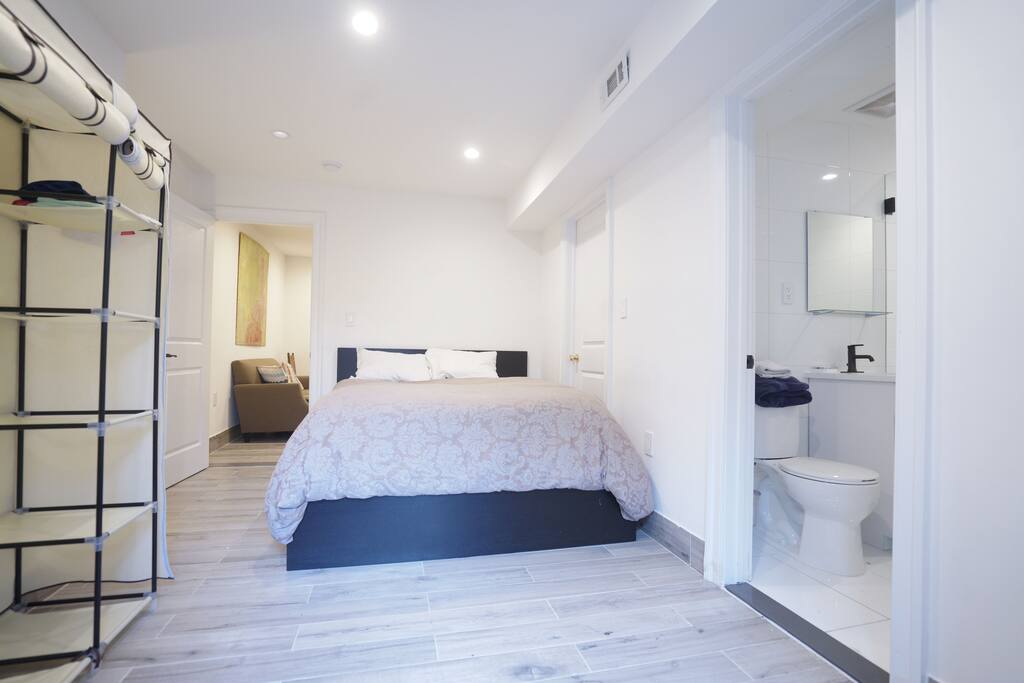 Large master bedroom with queen size bed with on suite bathroom and plenty of storage