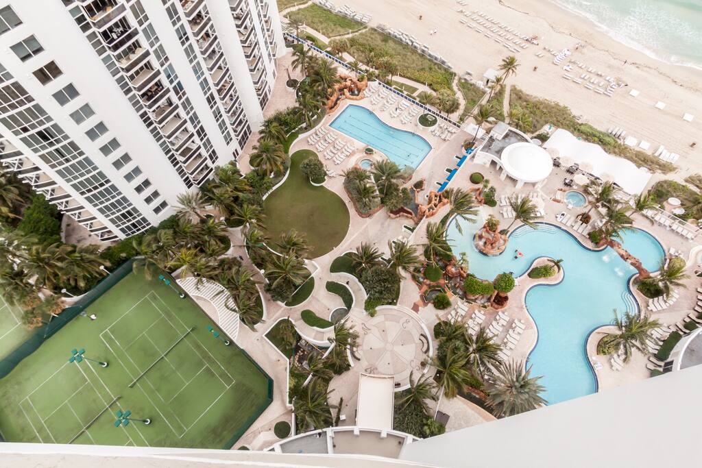 Top view of the resort's beautiful outdoor pools and beach amenities