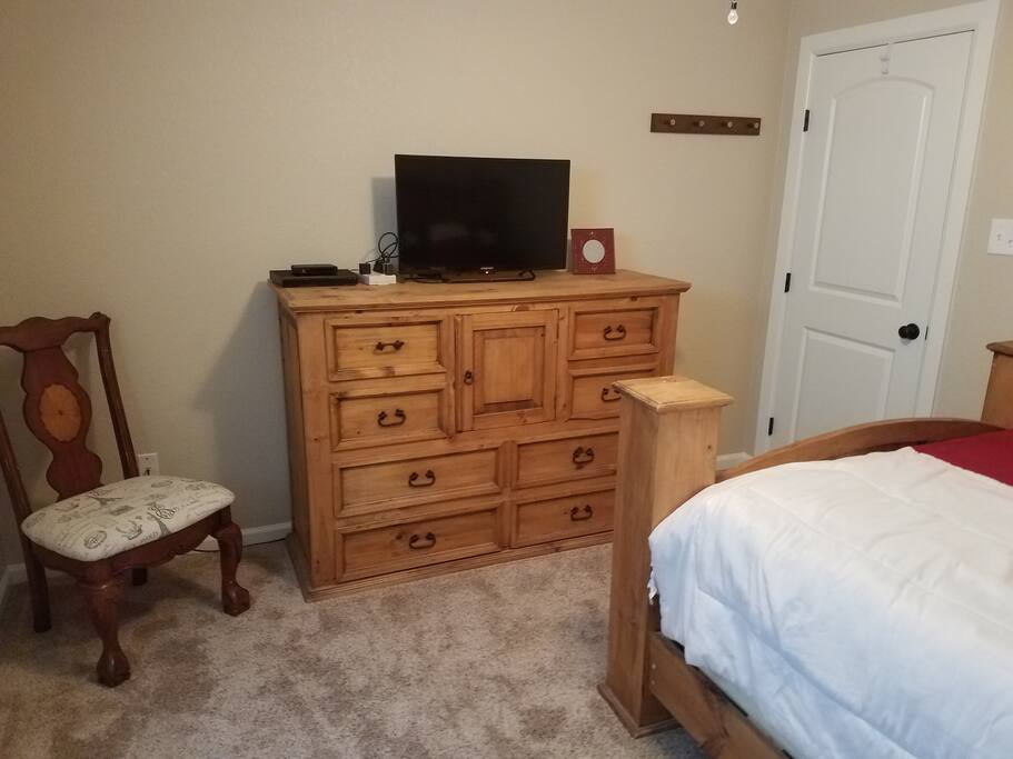 Dresser ,T.V. and sitting area in main bedroom