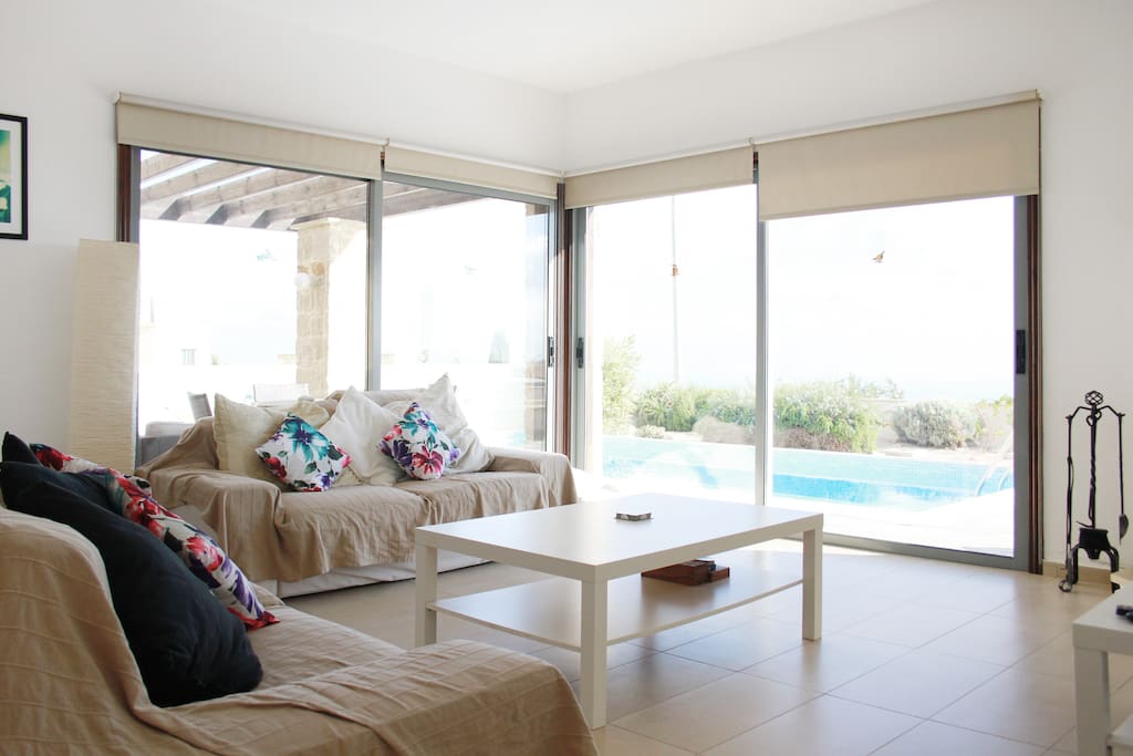 Spacious living room opening out to the pool with views to the ocean