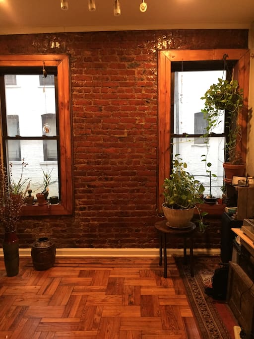 Exposed brick in the living room. Windows in every room open to quiet courtyard.