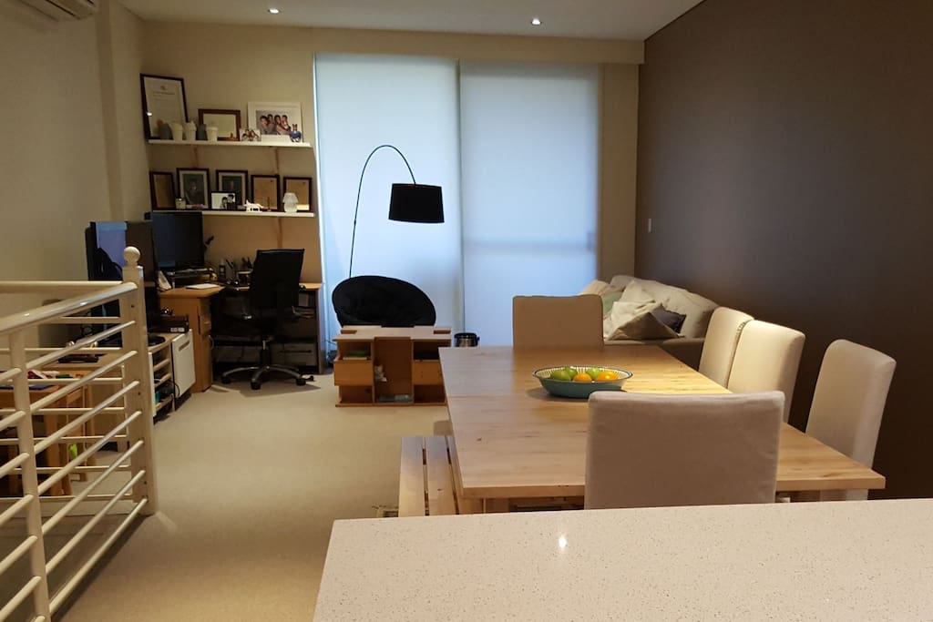 Spacious living and dining area with dining table that sits 8 (can be extended to fit 10-12), comfortable lounge and study desk.