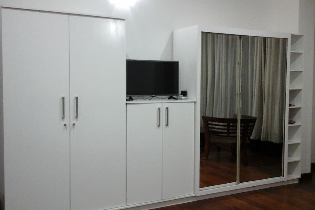 Master BR with a TV and built in wardrobes