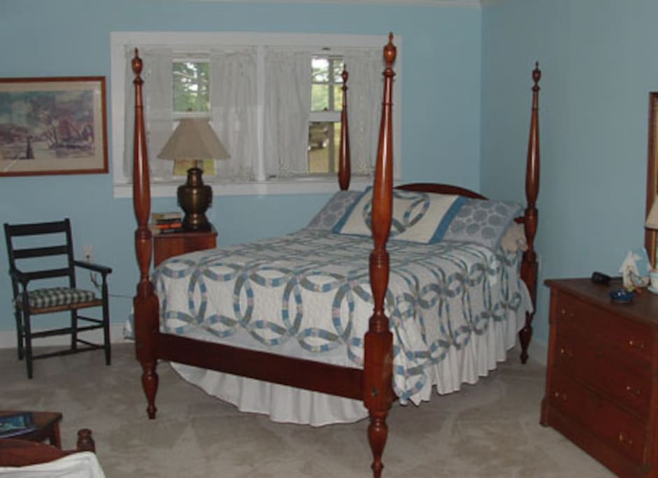 Large bedroom in cottage with double bed.