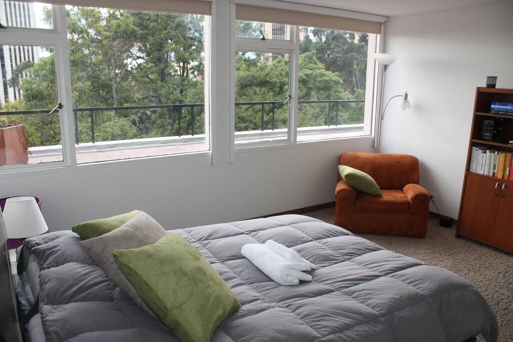 A clean spacious room with clean towels