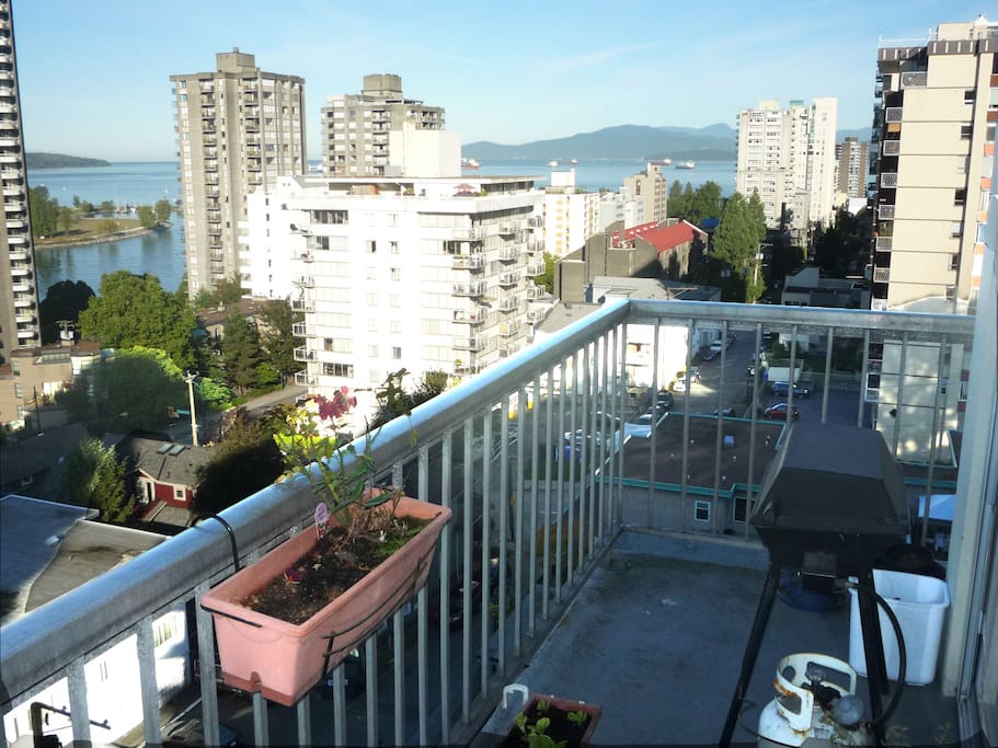 Daytime view of city and English Bay from balcony