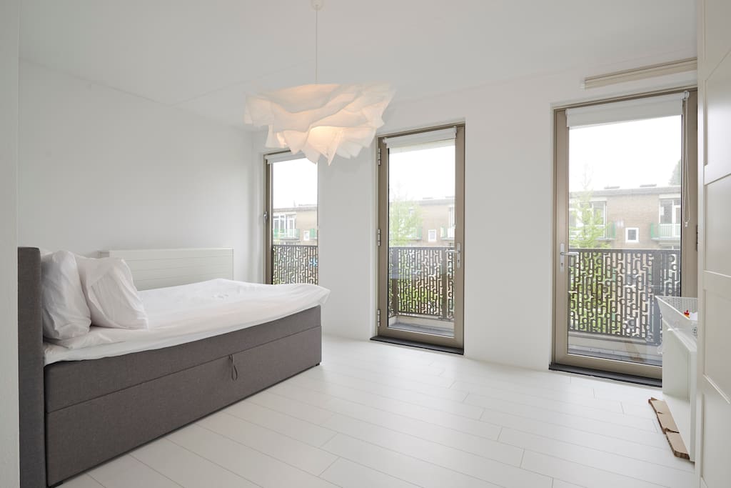 The bedroom has large windows,