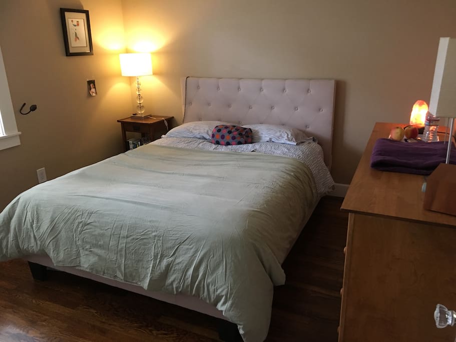 Simple, minimalist, quiet bedroom with ceiling fan, drawer space, and memory foam mattress topper