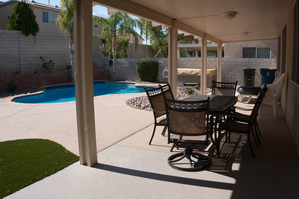 Backyard with covered patio, 8ft deep lagoon pool and above ground hot tub