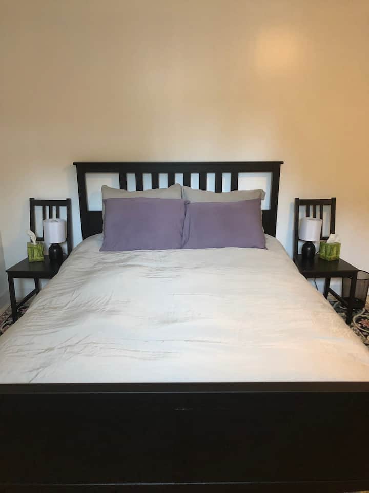 Queen bed located in bedroom