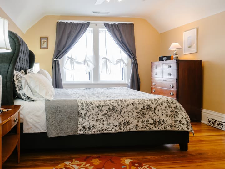 Gray bedroom has TV with DVD collection