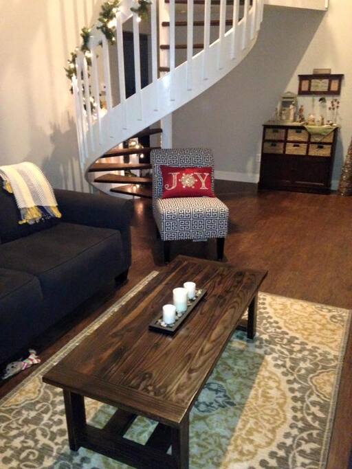 two story living room with spiral staircase inside main entrance