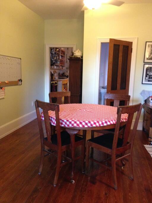 Table often gathering place with laptops and iPads, printer available.