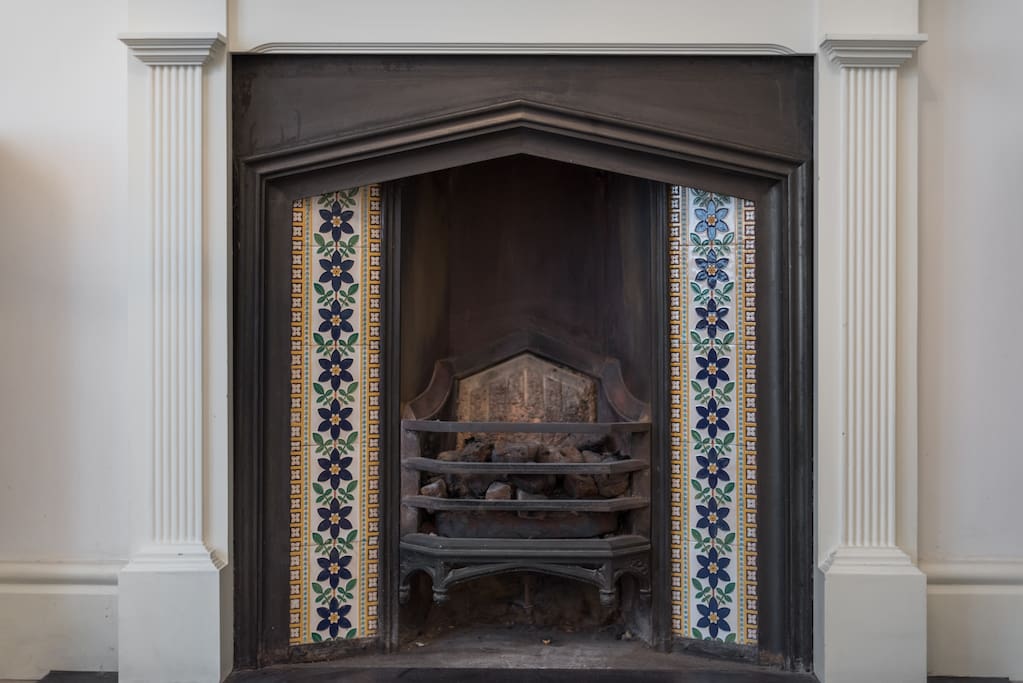 Original Victorian features populate the flat, including these classic antique fireplace tiles