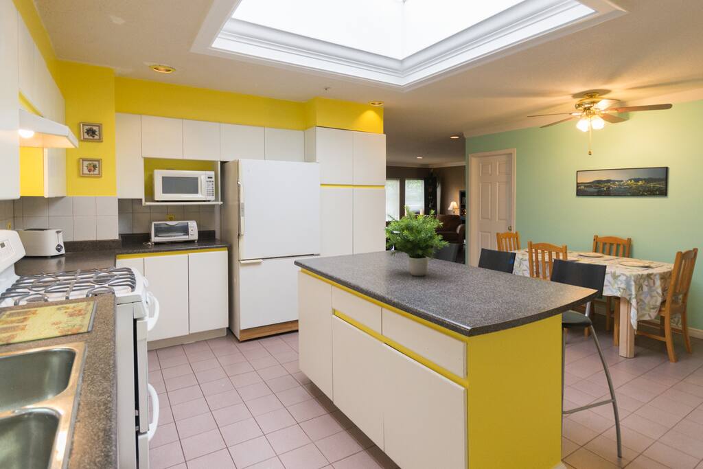 The bright and spacious kitchen is fully outfitted with everything you'll need to prepare and enjoy large meals together :)