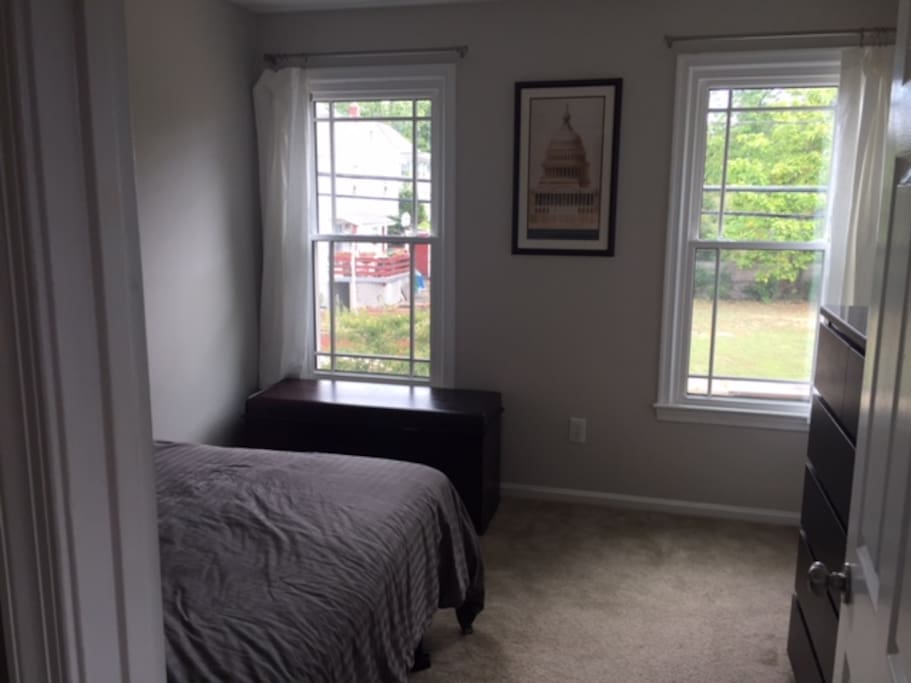 Bedroom #1, with empty dresser and luggage rack