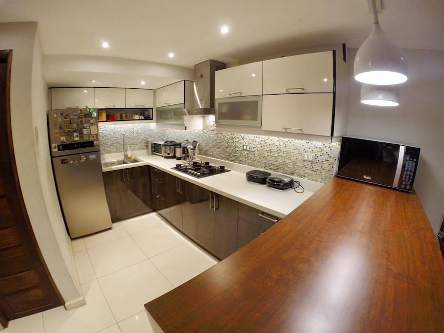 COMMON KITCHEN DOWNSTAIRS | Free use of our kitchen. Just provide your own ingredients when cooking. Utensils and cutleries are provided. Water from the faucet is filtered and drinkable. Ice and cold water are available too in the fridge.