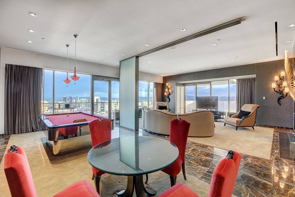 Large dual living room with game room, 60 inch flat screen television,a nd more