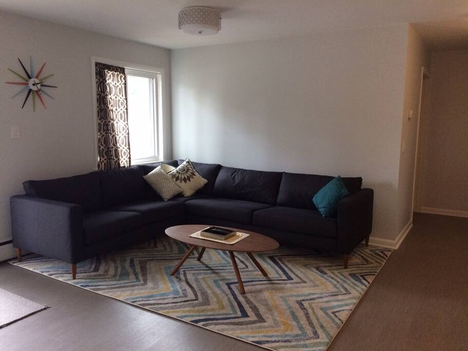 Basement lounge with seating for everyone and easy access to the back deck, grill, and backyard!