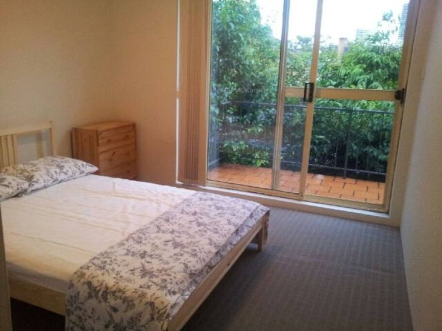 Bedroom with double bed, drawers, desk, chair & hanging space