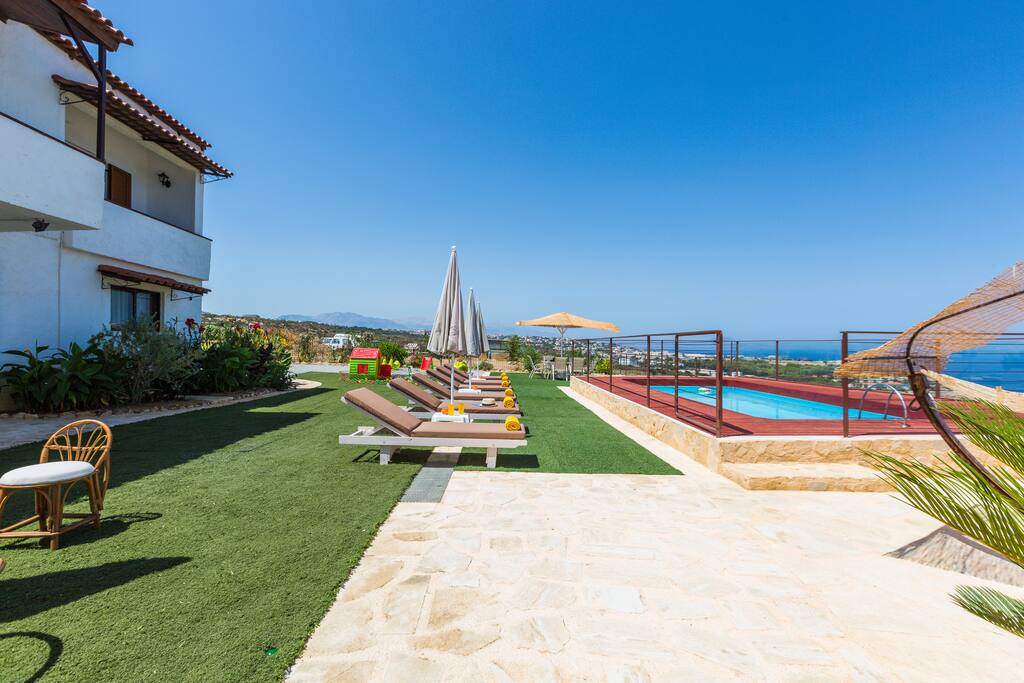Huge outdoor area with pool, sun beds - umbrellas, sitting areas, hammocks, dining area, playground