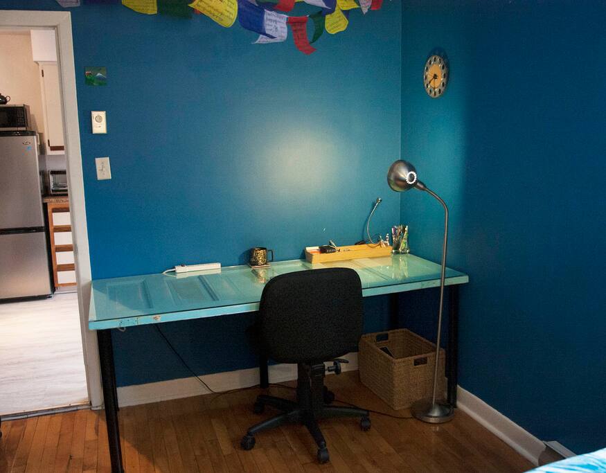 Work space for laptop - complete with power bar, multi-USB charger, ethernet cable, lamp, spare USB keyboard and mouse, pens and post-its.
