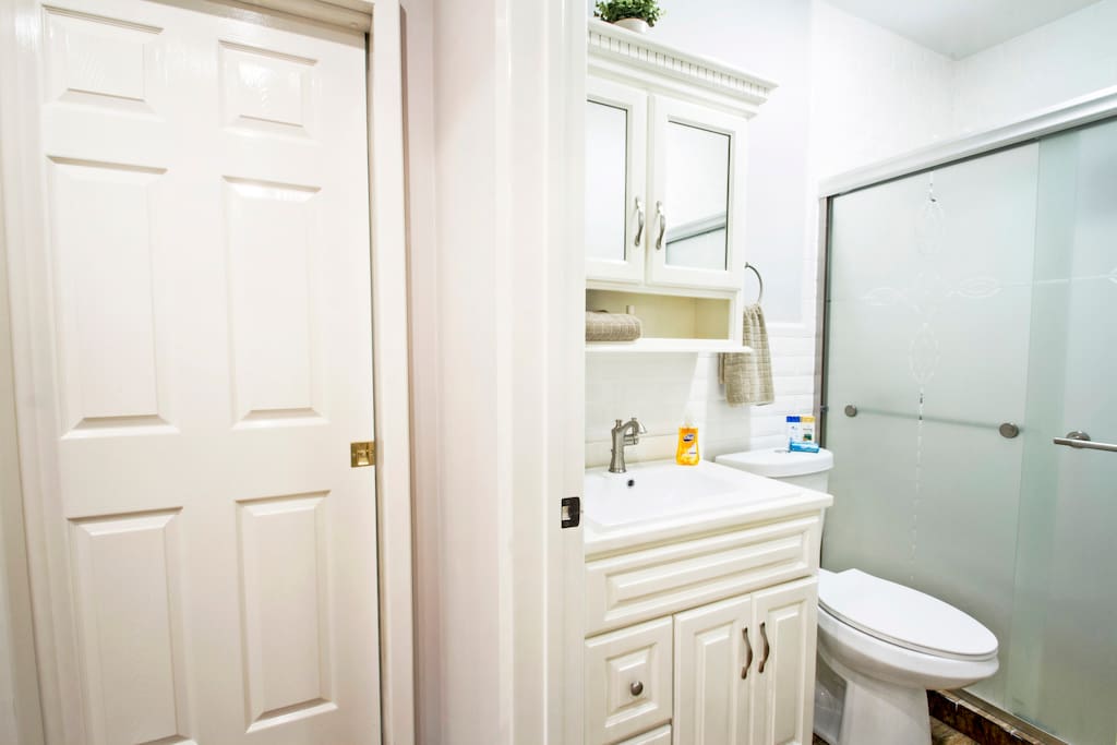 Bathroom with Essentials (Hair Dryer, Shampoo, Conditioner, Hand Soap, Towels)