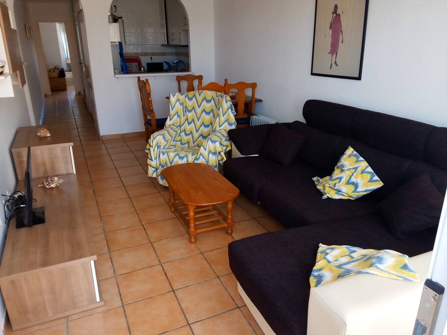 Living room with integrated kitchen. New sofa chaise-longe