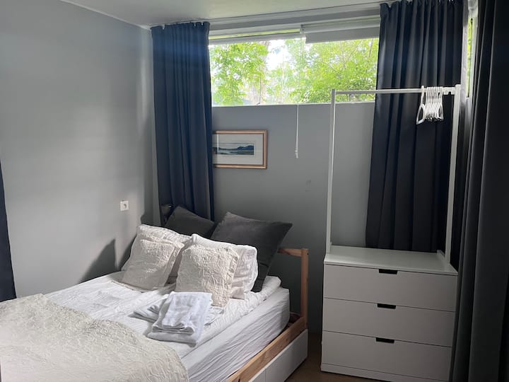 The bedroom has Double bed, queen size and double layer of curtain to darken the sleeping space during the bright summer nights. Drawers and some space to hang up shirts and clothes