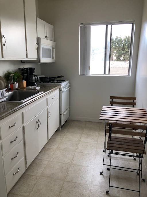 Full kitchen with fridge and microwave and granite countertops