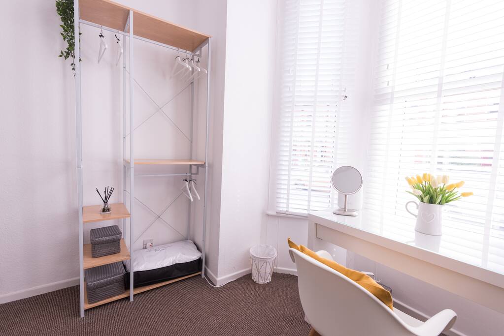 Open wardrobe, desk and hairdryer.