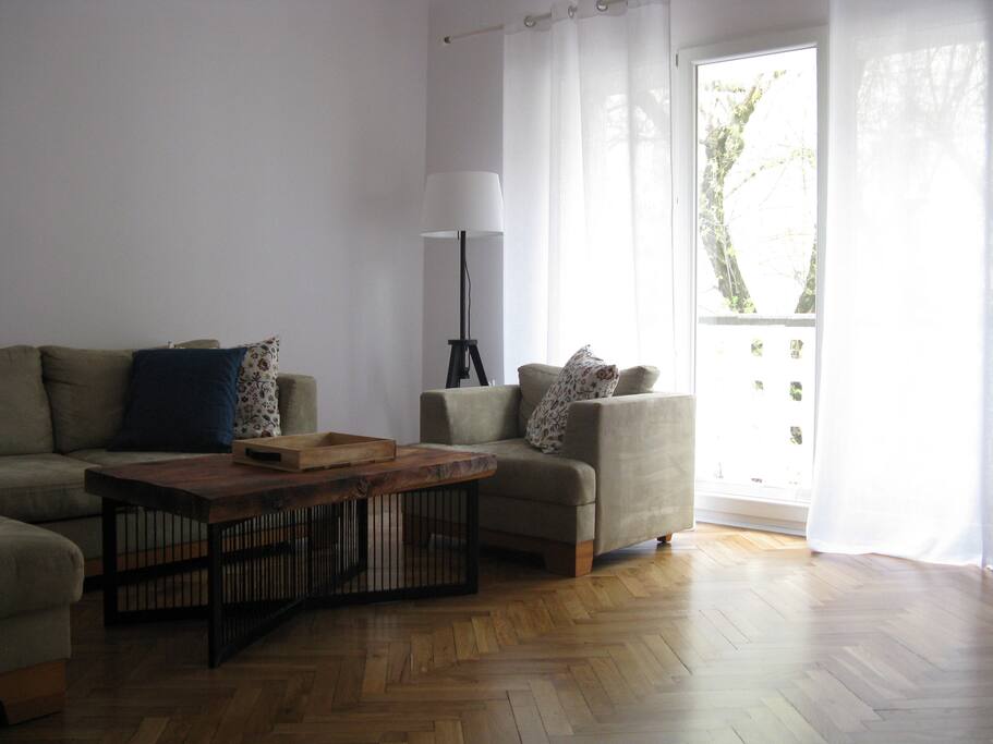 Living room with sofa-bed and a small balcony