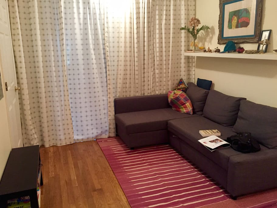 A close-able curtain separates the living room from the bedroom.