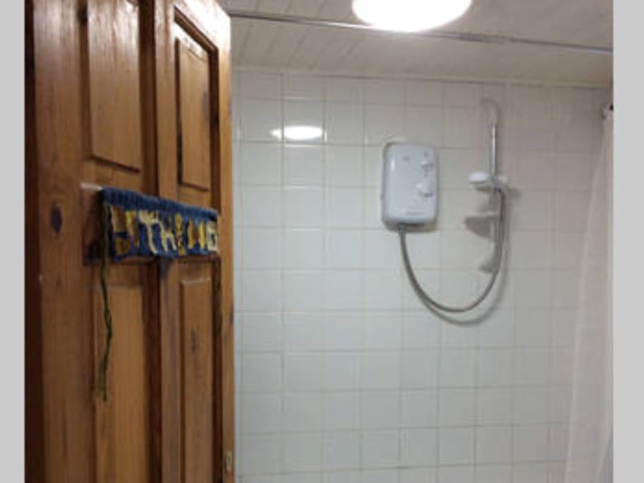 Shared bathroom with shower facility.