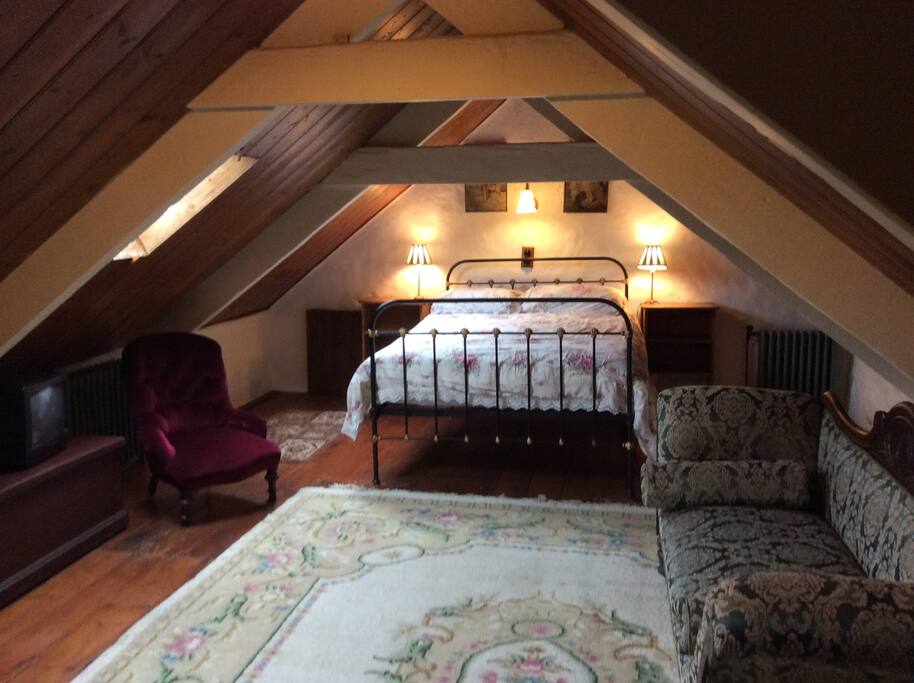 Large bedroom with cast iron bedstead.