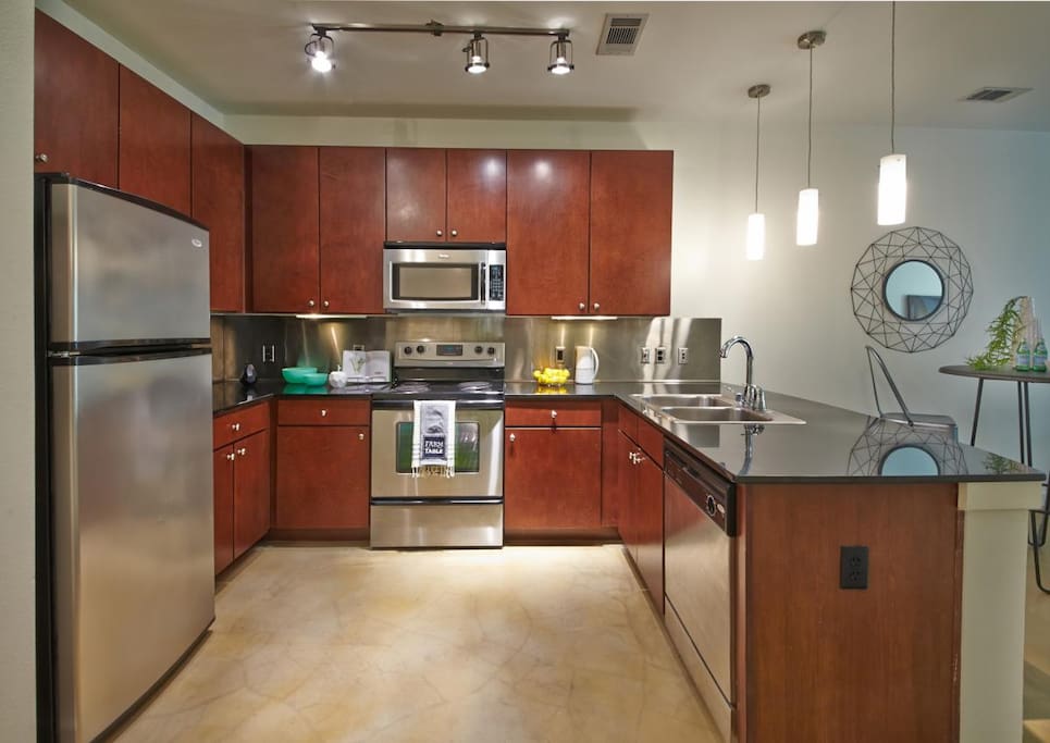 Full kitchen with stainless steel appliances.
