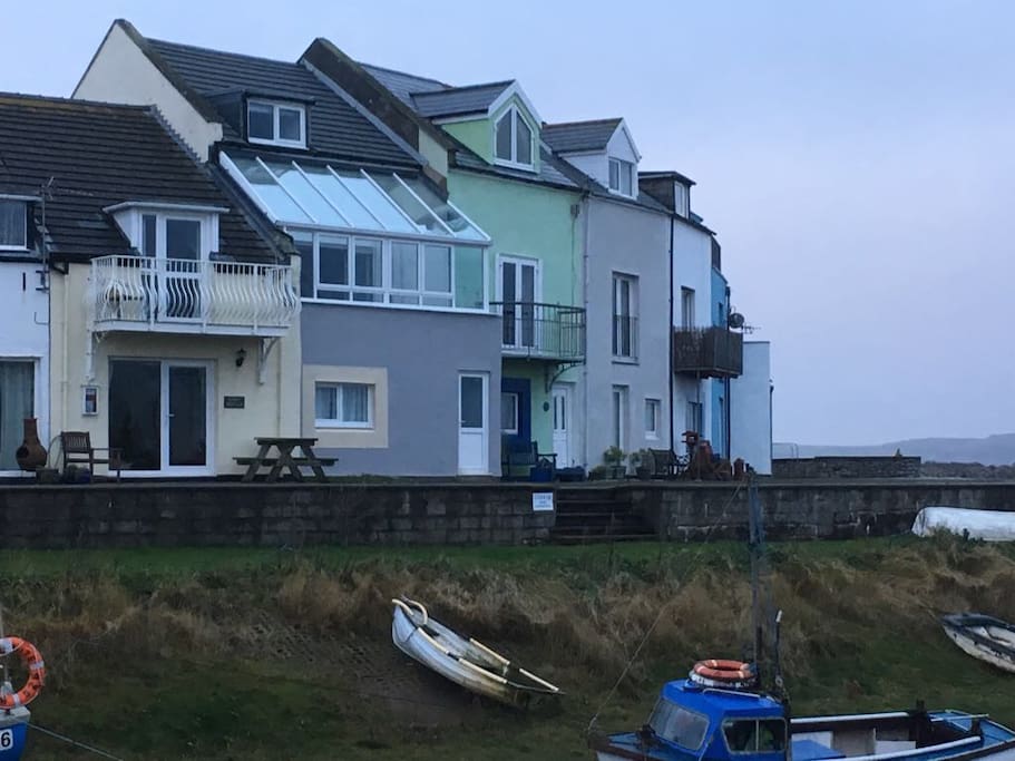 It's the grey one with a conservatory on first floor.