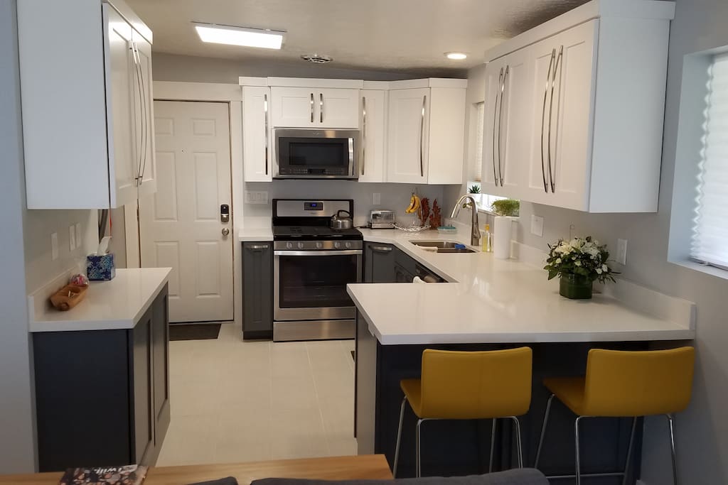 Full kitchen with gas range, dishwasher, fridge, and microwave.