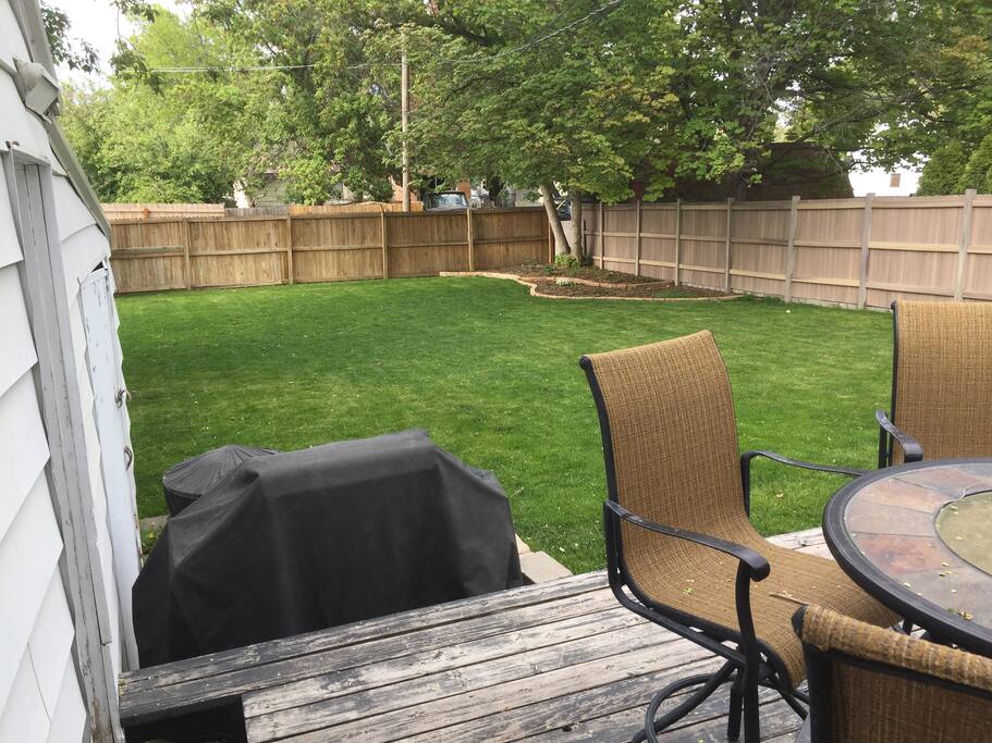 Backyard - Propane grill and lawn chairs available for use.