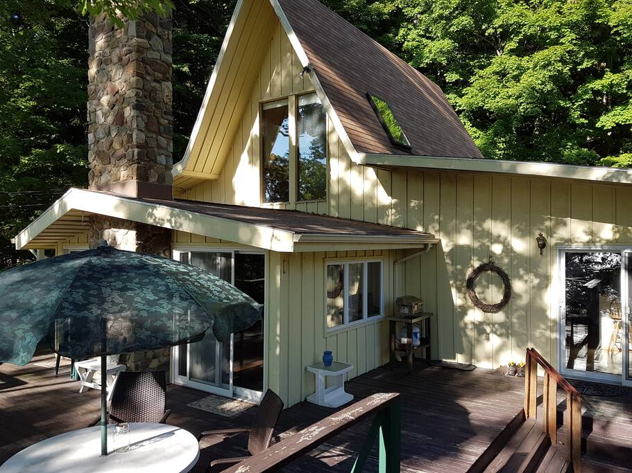 Front of house with deck, outdoor seating and grill
