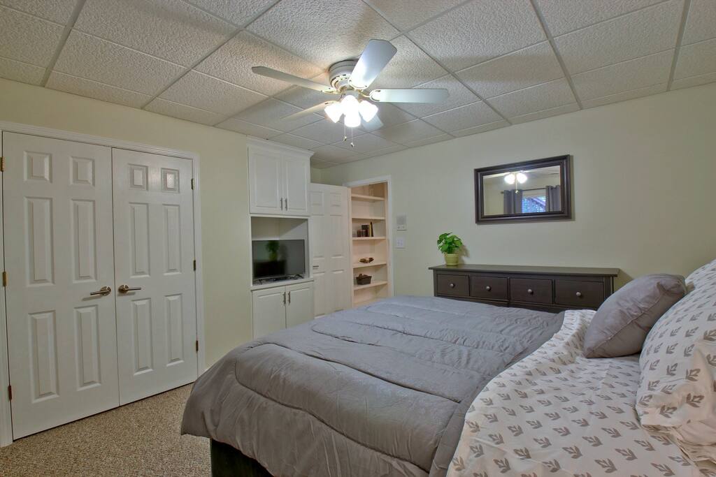 Bedroom with queen-sized bed and HDTV