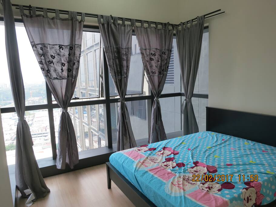 Bedroom 1 furnished with queen size bed and fitted wardrobe with night view.