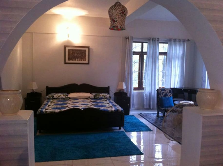 The interiors of the cottage with a bedroom, sitting area, fully equipped kitchen, private bath, balcony and terrace