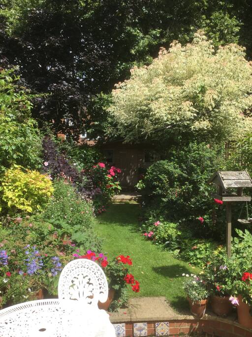 The glorious garden and pond equipped with table, chairs for outside dining and sun loungers.