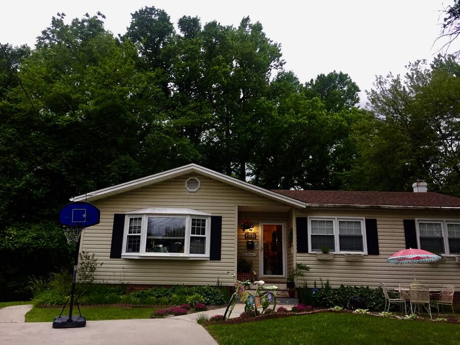 The entrance to the room is to the left of the house.